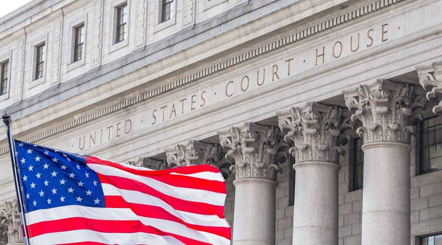 USA national flag waving in the wind in front of United States Court House in New York
